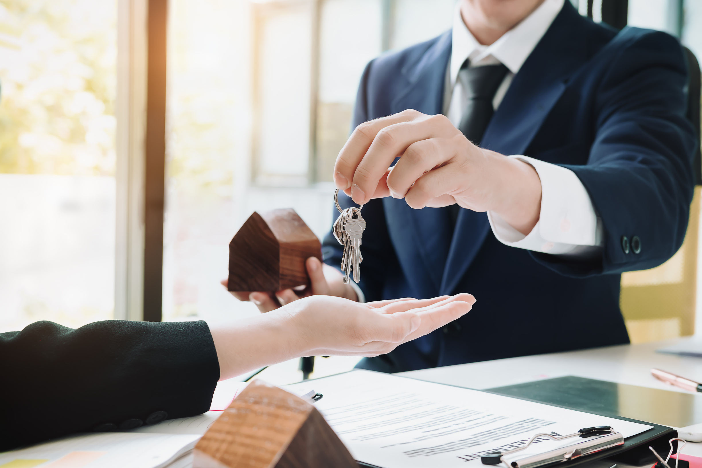 Real Estate Agent Giving House Key to His Client